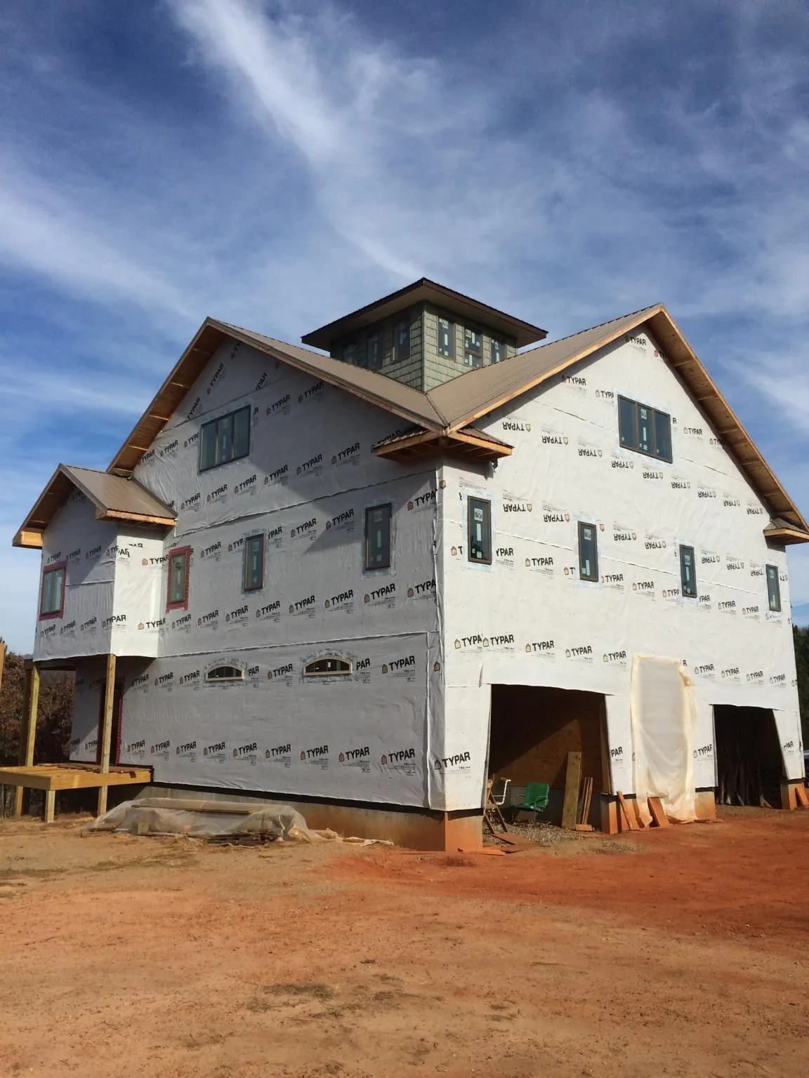 New two story house under construction with a cupola and gabled roofs in Summit Argo